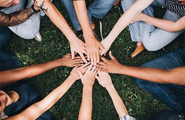 people stacking hands together